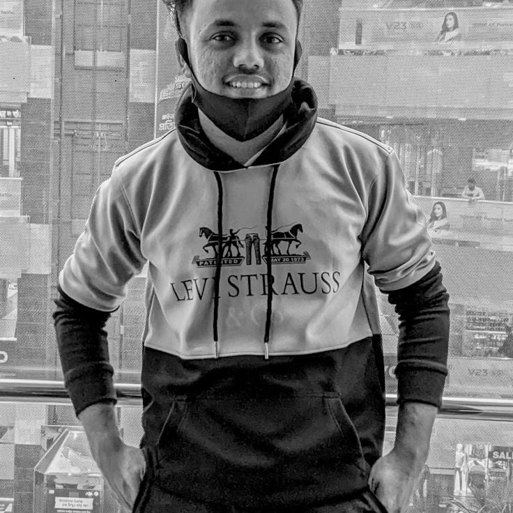 A person named Aisha Singh, Lead Design Curator at Timber Haven Route, reviewing corporate floral arrangements